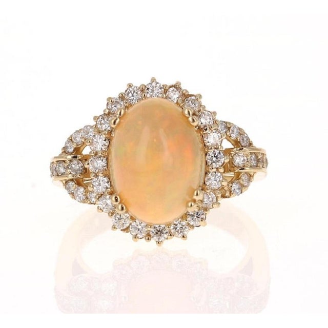 This beautiful and classic piece has a 3.59 Carat Oval Cut Opal and is surrounded by 46 Round Cut Diamonds that weigh 0.82...