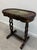 A striking antique chinoiserie-inspired accent/tea table featuring richly detailed japanned decoration, gilt floral...