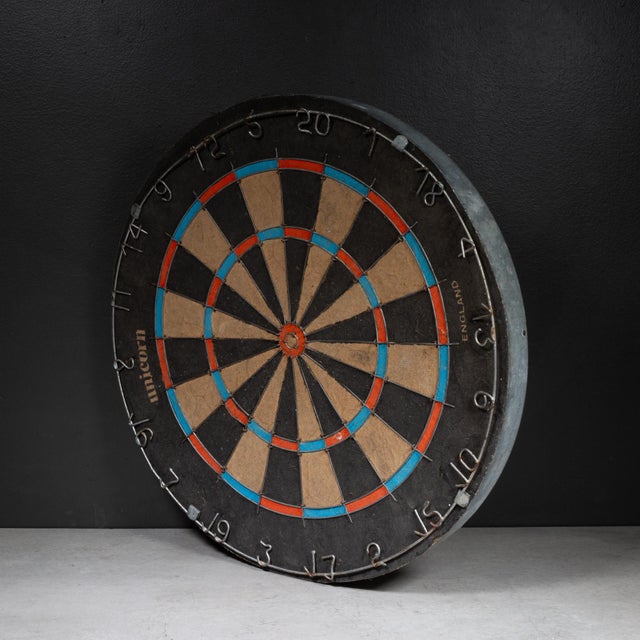 ABOUT A vintage Unicorn brand dartboard manufactured in England. The board features a traditional wire spider for the...