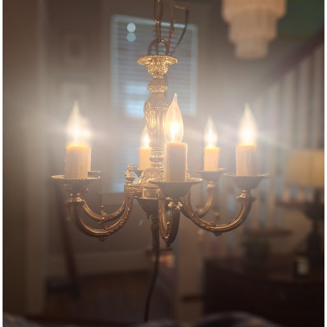 Lovely solid brass six-arm chandelier with detailed ceiling escutcheon. Wired and working. Faux drip candle socket covers...