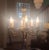 Lovely solid brass six-arm chandelier with detailed ceiling escutcheon. Wired and working. Faux drip candle socket covers...