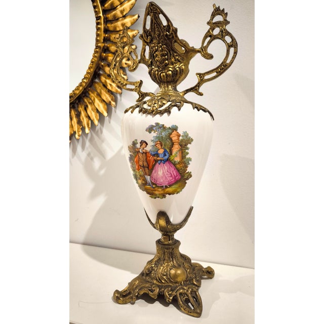 Spectacular bronze and porcelain vase from the 1950s, originating from France. Rising from a bronze base carved with...