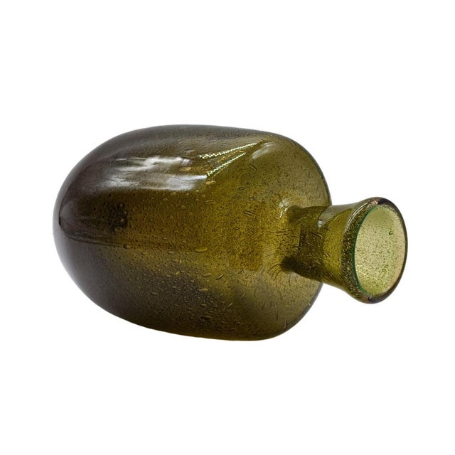 A splendid and refined Murano glass art vase, featuring an elegant bottle-like silhouette with a flared neck. This piece...