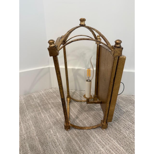 French provincial style sconce in gilded distressed brass.