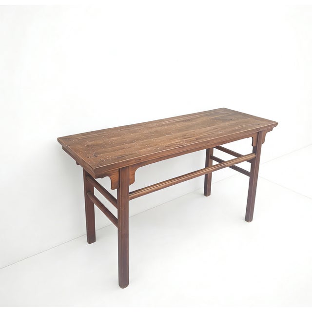 This early-19th century walnut wood table features a flush-panel top with a clean, rectangular silhouette. Constructed...