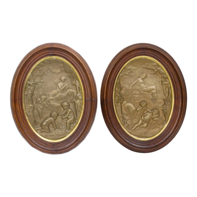 Oval Patinated Metal Wall Plaques with Cherub Decorations - A Pair For Sale