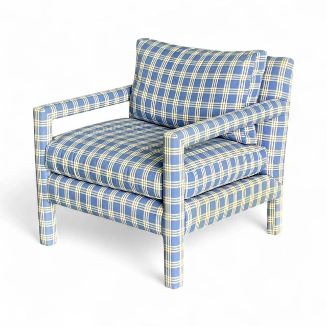 Make a statement with this charming plaid-upholstered lounge chair — a perfect blend of comfort and tailored style. The...