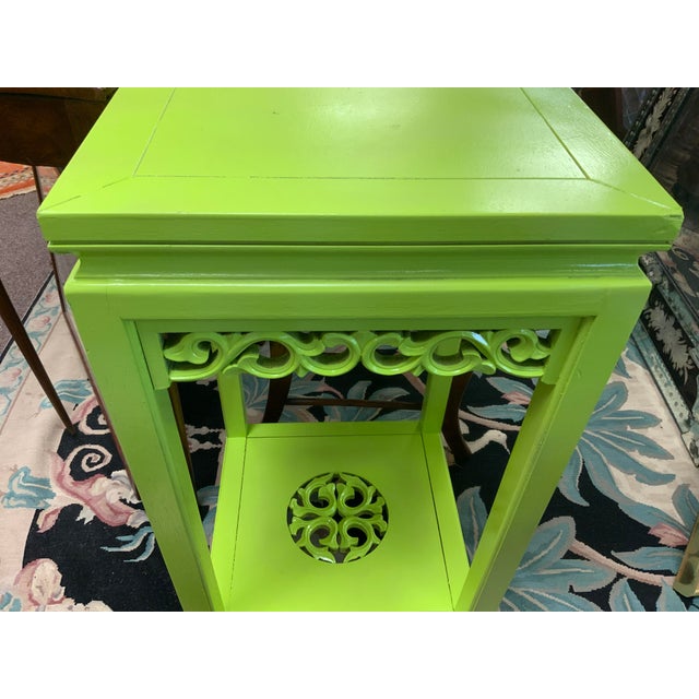 20th century chinoiserie tall side table. Painted in a bright green over original finish. Pretty carved details along...