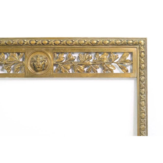 Bronze Regency fireplace insert with lion head motif. The manufacturer and exact date of creation are unknown. The...