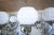 Eight-arm chandelier made of white brass. The body of the chandelier is decorated with plant motifs. Shades made of white...