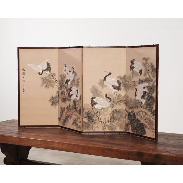 A beautifully composed Japanese style four-panel Asian byōbu screen depicting a flock of red-crowned (Manchurian) cranes...
