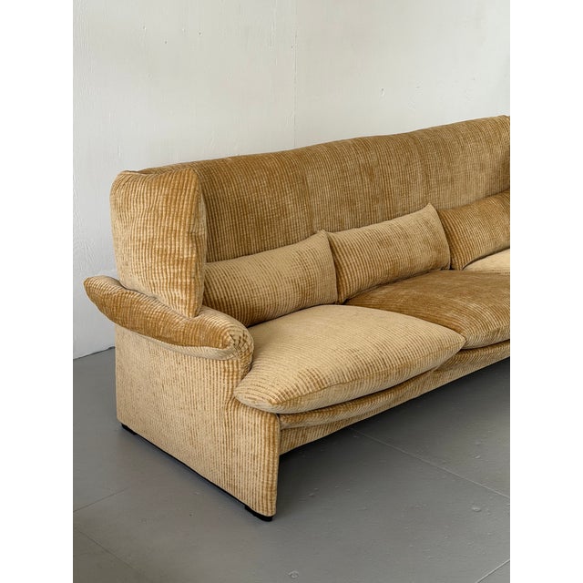 The three-seat companion to Magistretti's adjustable wingback design, built on the same idea: side headrests that move to...