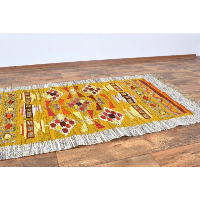 This hand-woven wool and linen wall rug produced in Poland in the 1960s. The rug shows a folk pattern, characteristic of...