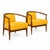 Modern mid century lounge chairs done in a yellow chenille upholstery. The chairs have a walnut finish. The chairs are...