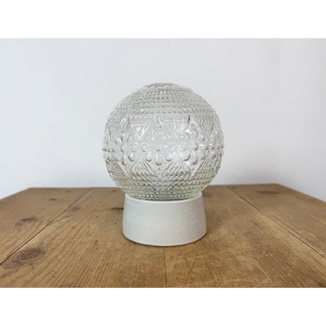 Vintage industrial ceiling or wall light made in former Czechoslovakia during the 1970s. It features a white porcelain...