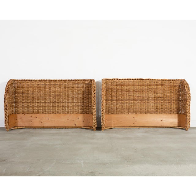 A pair of charming late 20th century Italian woven rattan wicker headboards or bed surrounds, each executed in a warm dark...