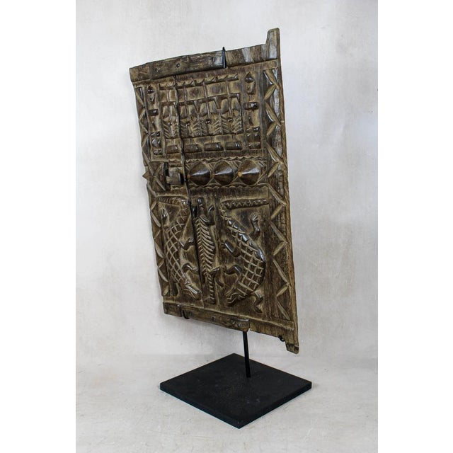 Dogon granary doors originate from the Dogon people of the Bandiagara Escarpment region of Mali. These doors protected the...