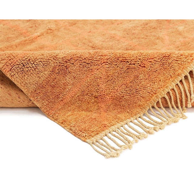 Vivid hand-knotted wool rug with a gradient from Orange Ochre to Saffron, adorned with subtle Vibrant Orange geometric...