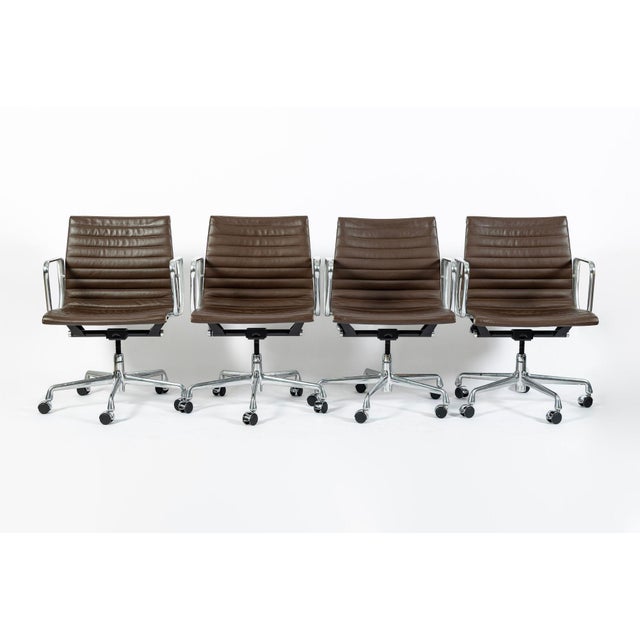 This set of four authentic Eames for Herman Miller Aluminum Group Thin Pad office chairs were manufactured in 2008 (50...