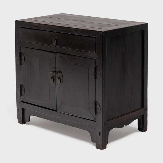Crafted of elm with traditional joinery, this antique Chinese side cabinet has clean lines and an uncluttered design....