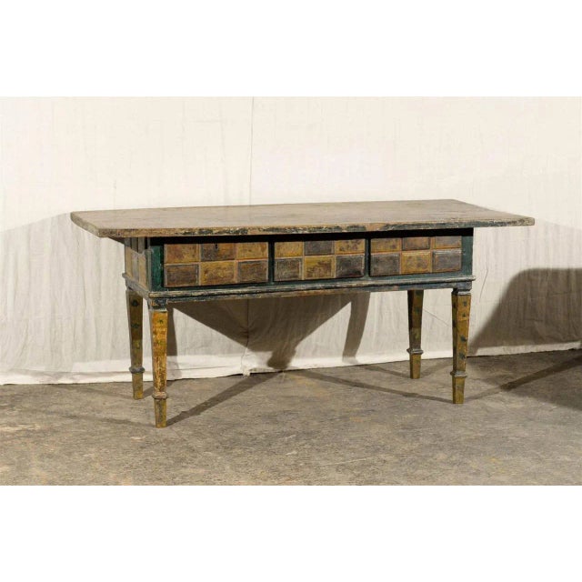 A 19th century or earlier Spanish console or center table. This table is very unique in its alternating color decorations...