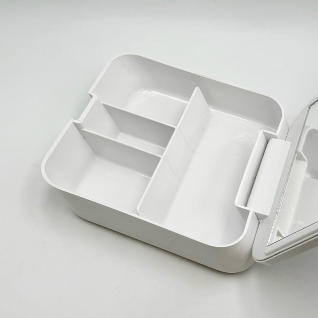 A compact Space Age vanity set with integrated mirror, designed as a sculptural personal object rather than a simple...