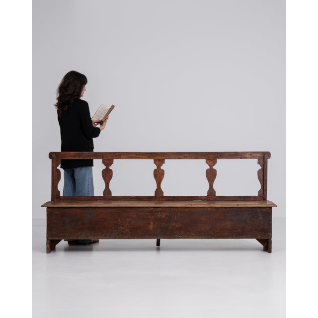 A 20th century Italian bench featuring a wooden structure with an upholstered seat. The design reflects a balance between...