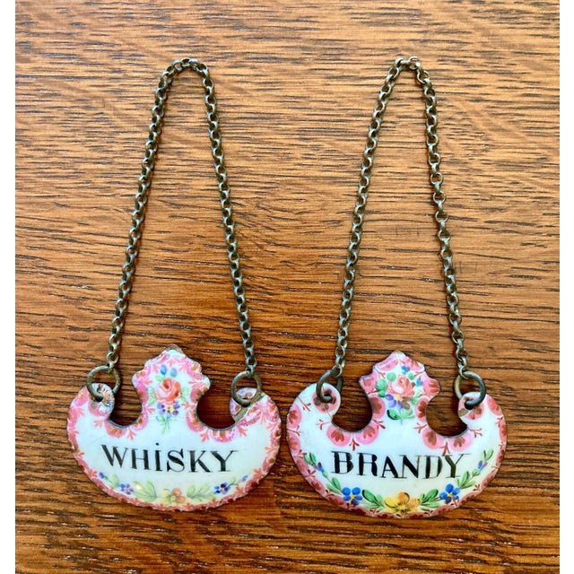 A rare pair of Georgian period Bilston enamel on copper decanter labels with original dual link brass chain. One for...