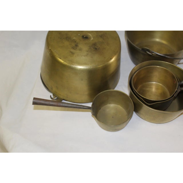 Good condition solid brass cooking pots. From an Antique dealer in LA. They have hand made steel handles that are Riveted...