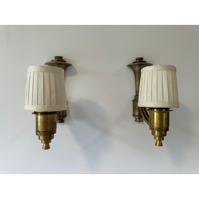 English cast brass Sconces, 19th. century design with scrolling arm a light and shaded holder, these are sand cast hand...