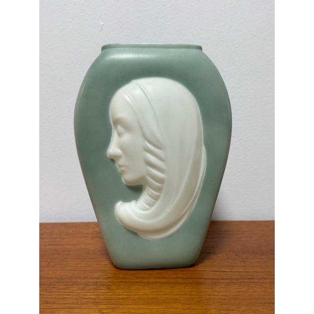 Striking Art Deco figural vase featuring a sculptural female profile rendered in high relief. This elegant piece showcases...