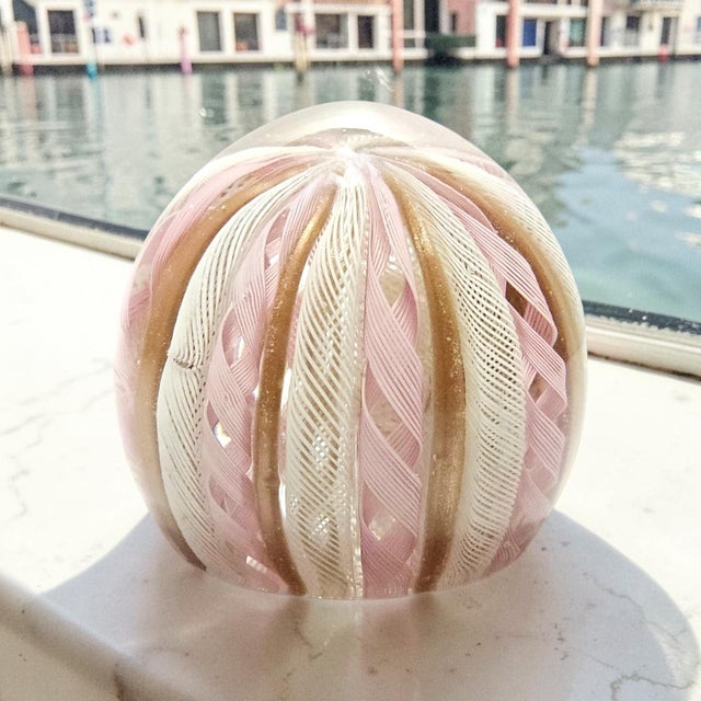 An authentic mid-century Murano art glass paperweight, hand-blown in Italy and retaining its original embossed silver...