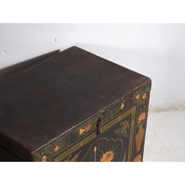 Antique painted Chinese trunk in pine wood, provincial painted furniture with lotus composition originating from Inner...