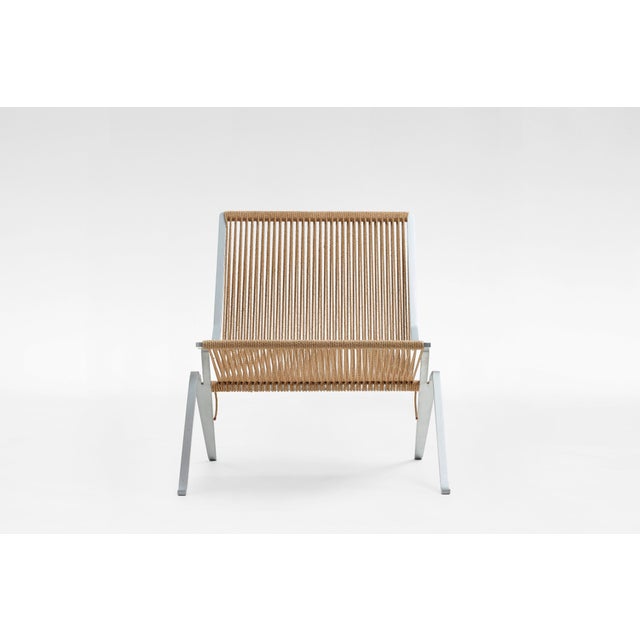 PK25 lounge chair designed by Poul Kjærholm and manufactured by Fritz Hansen. Featuring a natural beige flagline seat and...