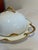 This elegant domed covered dish is by Haviland & Co., Limoges, France, featuring a sculptural gold gilt handle atop the...