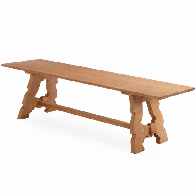 This beautiful country dining table features a thick rectangular top supported by two substantial carved legs, angled...