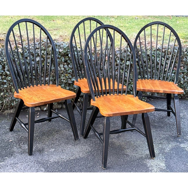 Rustic set of farmhouse Windsor chairs. Solid oak in black paint with natural seats. Bowback spindle design with tapered...