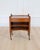Made in France in the twentieth century, this small cherrywood bedside table has a drawer opening at the front, two...