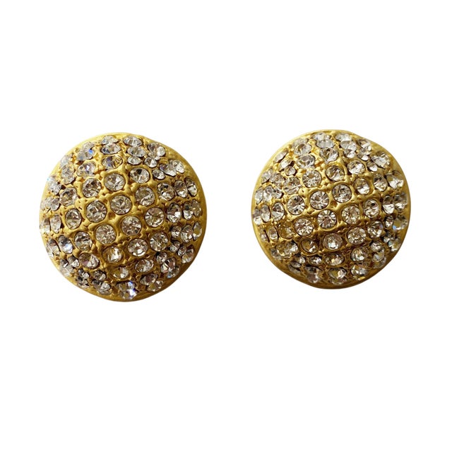 Crafted with timeless elegance, these clips round Dome earrings feature a sophisticated gold tone design adorned with...