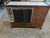 Buffet bar is walnut with white laminate on top with metal handle on each end to which the wheels are attached