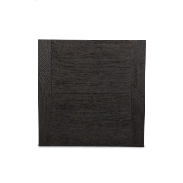 Black-finished oak shapes a streamlined end table with a rich yet minimalist look.