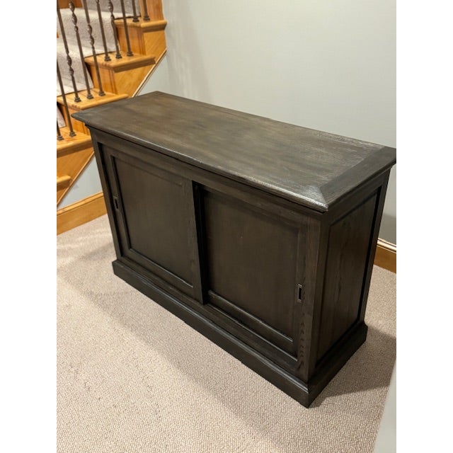 At the turn of the 20th century, well-made cabinets like this were often used by English shopkeepers to display their...