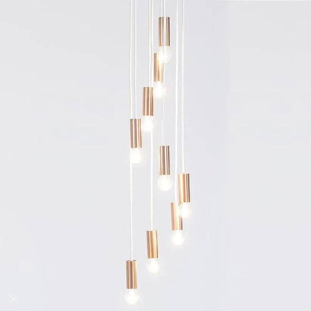 This cascading pendant was manufactured by Raak Amsterdam in circa 1970. It has nine brushed copper colored pipes and has...