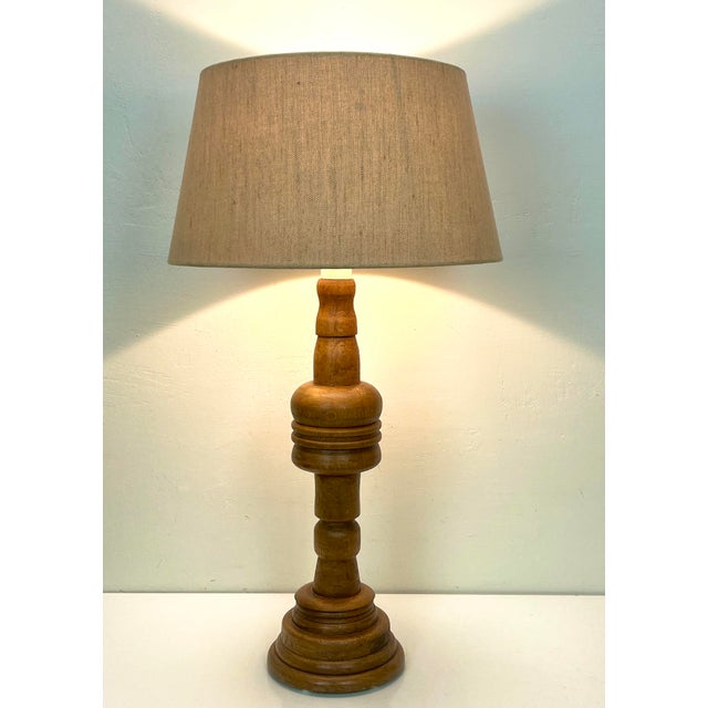 This large Mid-Century table Lamp is full of rustic sophistication, crafted of oak wood and featuring warm neutral hues...