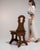 Carved walnut side chair in Rich Walnut Brown. The rich walnut brown surface highlights pierced scroll-carved backrest,...