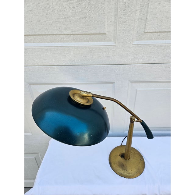 This mid-century modern industrial desk lamp is in the style of lamps by Oscar Torlasco for Lumi, with the thick...