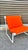 Add a pop of color to your home with this vintage pair of orange Sling chairs designed by Bruce Hannah & Andrew Morrison...