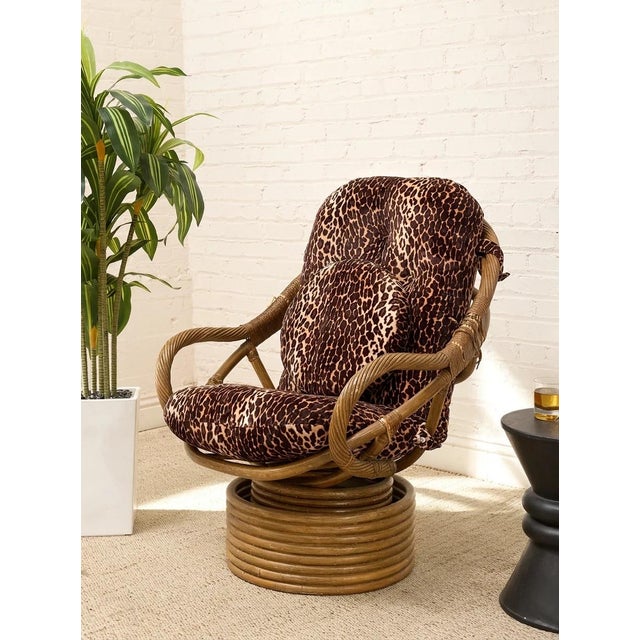 A wonderfully bold vintage tiki-style lounger featuring a sculptural bamboo frame paired with dramatic leopard print...