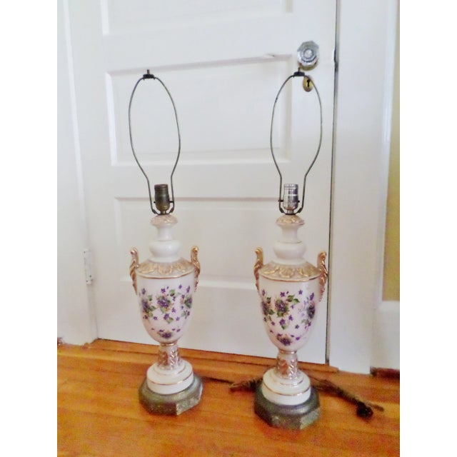This is an Vintage pair of ornate porcelain table lamps that have beautiful hand-painted violets on the front and back...
