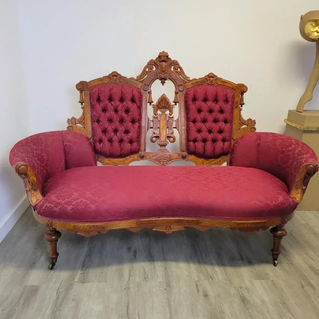 Step into the lush drama of the late Victorian era with this Renaissance Revival carved walnut loveseat, circa 1870–1890....